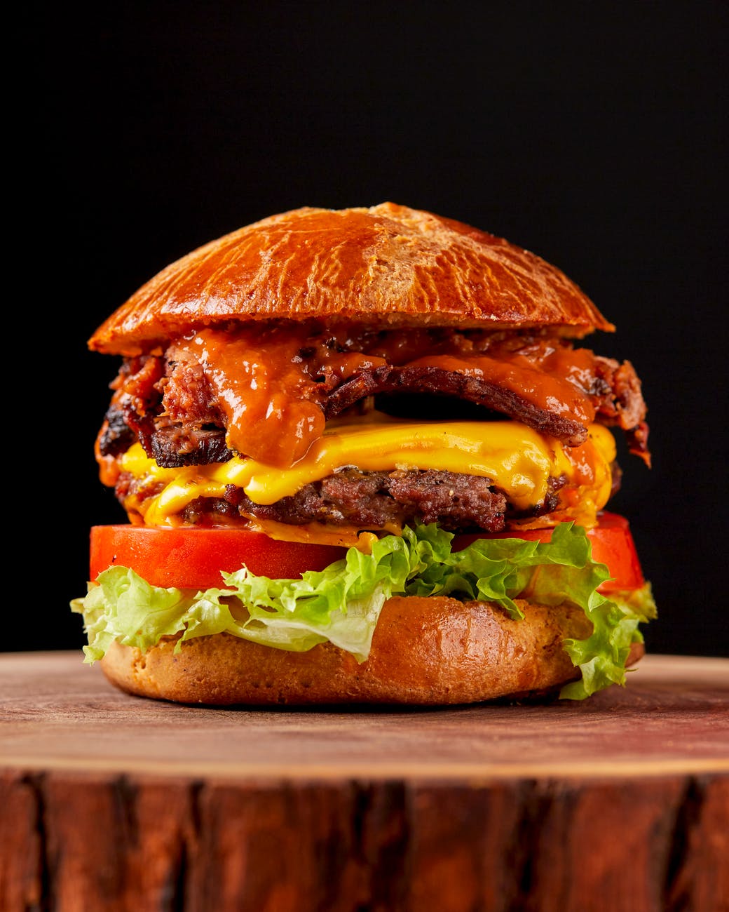 close up of a hamburger on black background