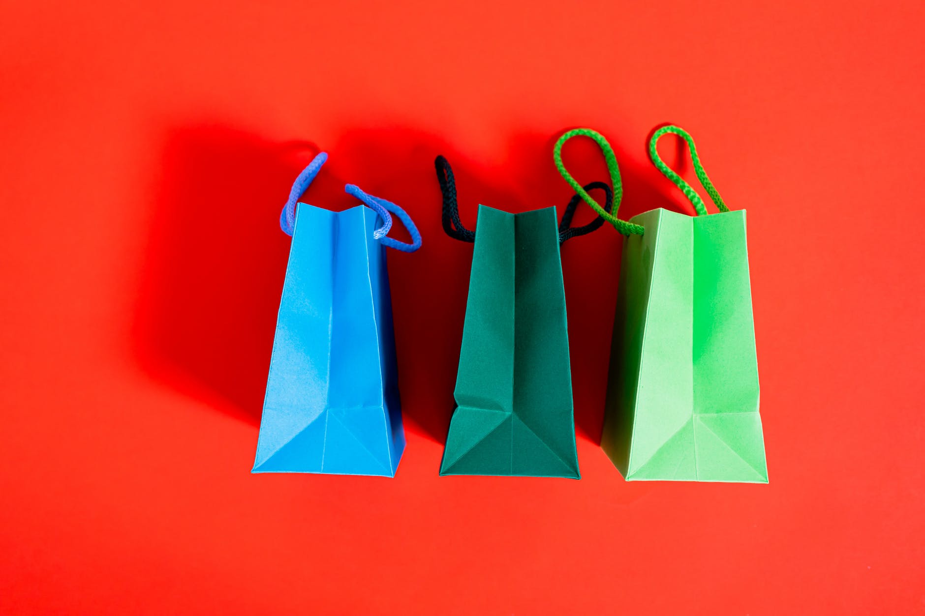 shopping bags on a red surface